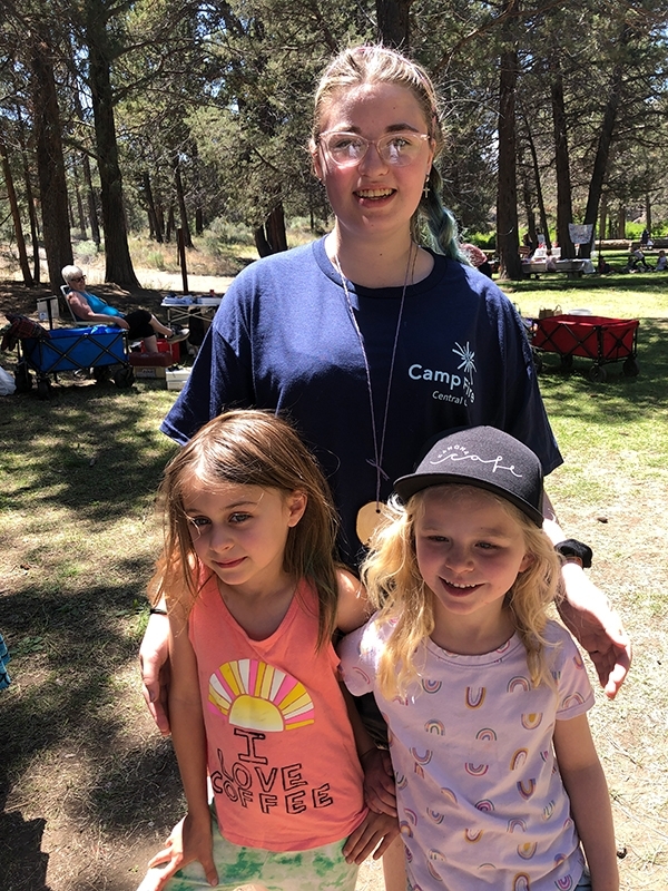 Two young campers and a counselor modeling their Camp Fire shirts