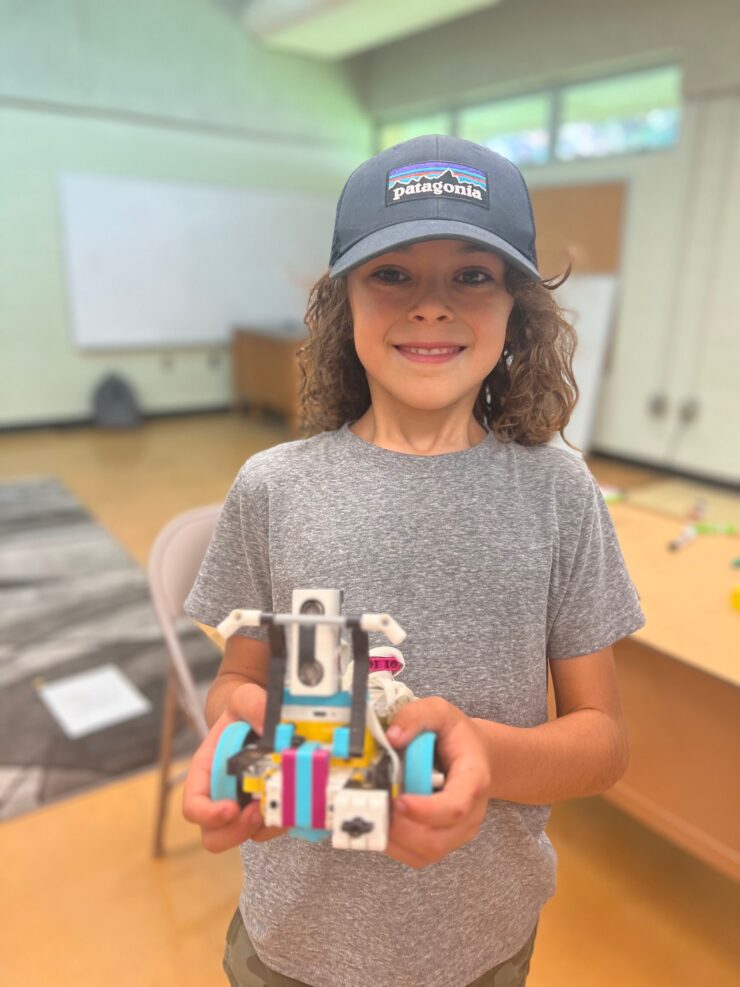 A camper holds up a LEGO robot