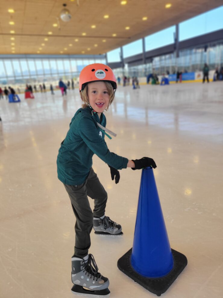 Boy skating on ice and smiling