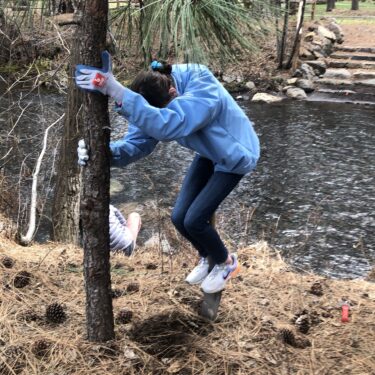 Teen Connects youth puts muscle into breaking up the riverbank for planting.