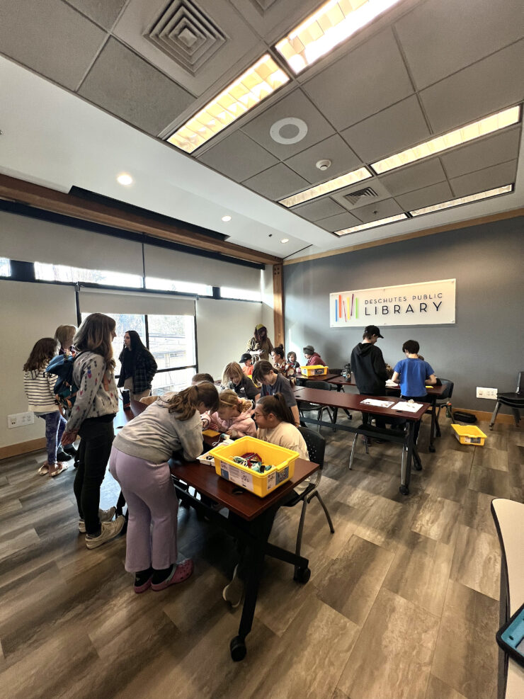 A crowd of kids and families participating at Bit(e) of Robotics at Deschutes Public Library