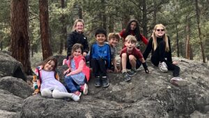 Afterschool kids posing on a rock in nature