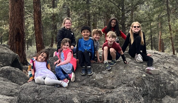 Afterschool kids posing on a rock in nature
