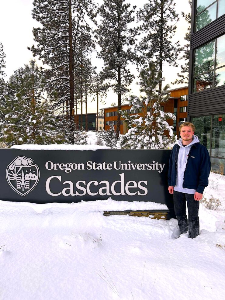 Harrison Feist standing in front of OSU-Cascades sign.