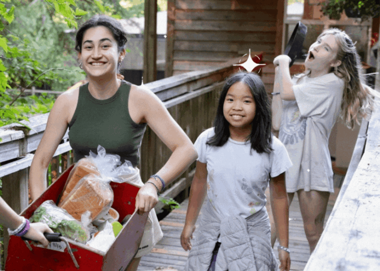 Kids carrying a box of dry goods.
