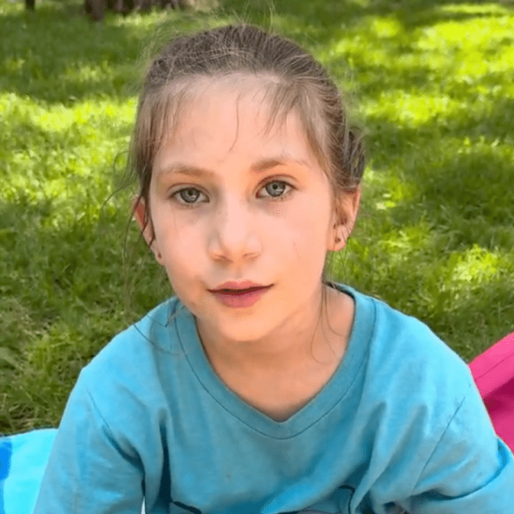 Girl sitting on the park grass.