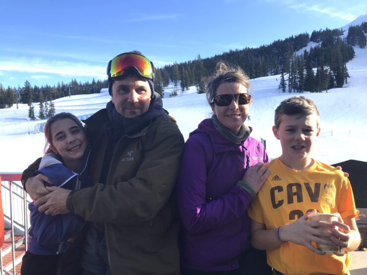 Family photo of Katie Roberts, her husband and children at a ski resort.