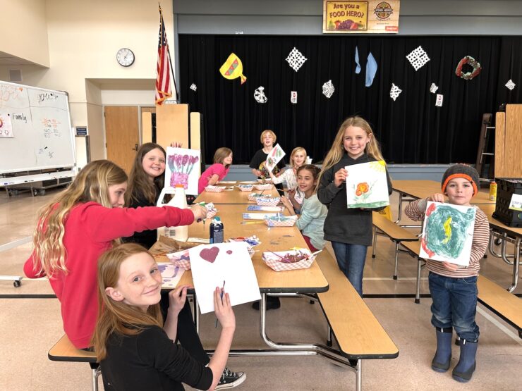 Youth holding artwork at Camp Fire Afterschool in South County