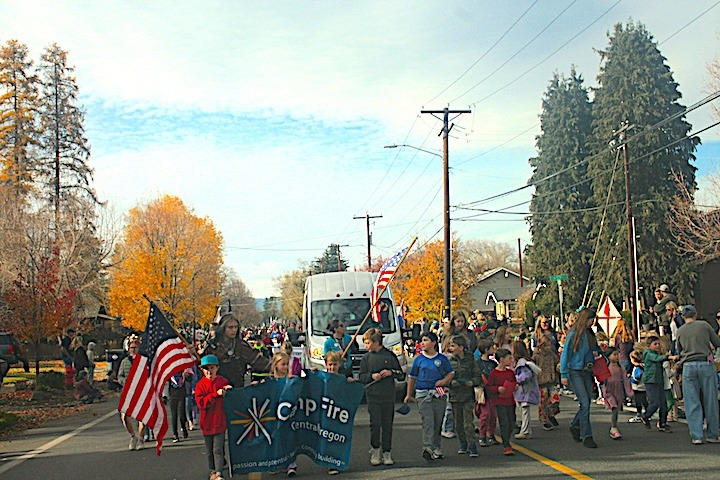 Camp Fire kids, staff and teens walking in a parade.
