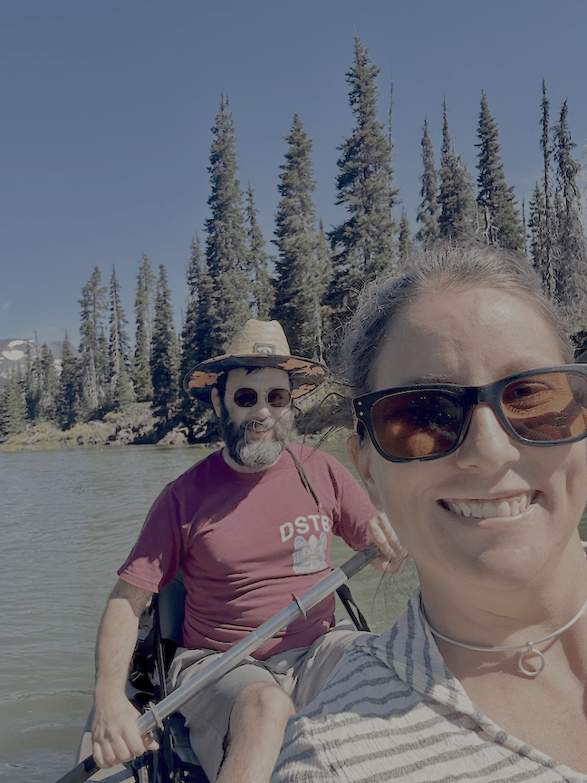 Jen Paynter and partner standing by a lake.