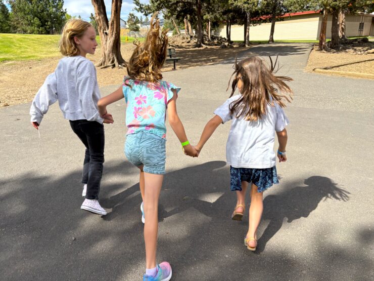 Three girls skipping
